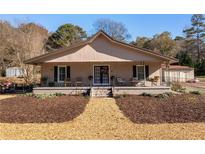Charming ranch home with a spacious front porch and well-manicured landscaping at 1404 Cassville Nw Rd, Cartersville, GA 30121