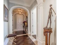 Elegant entry hall with arched doorways, hardwood floors, and decorative elements at 3376 Peachtree Ne Rd # 47A, Atlanta, GA 30326