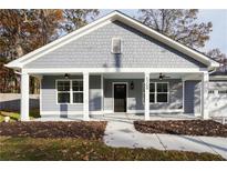 Gray house with white columns, front porch, and a two-car garage at 5359 Megan Rd, Stone Mountain, GA 30088