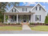 Charming two-story home with a welcoming front porch and landscaped yard at 527 Main St, Suwanee, GA 30024