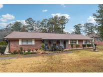 Brick ranch home with carport and landscaped yard at 747 Bethesda School Rd, Lawrenceville, GA 30044