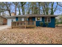 Ranch home with blue exterior, wood ramp, and mature trees at 1089 Indale Sw Pl, Atlanta, GA 30310