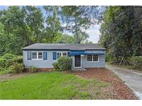 Ranch style home with blue shutters and a landscaped yard at 2436 Clarissa Nw Dr, Atlanta, GA 30318