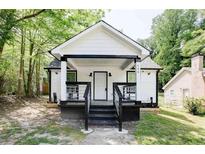Charming white cottage with black accents and a welcoming front porch at 406 Illinois Nw Ave, Atlanta, GA 30314