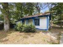 Charming white house with blue accents, a covered porch, and a small yard at 1321 Mcclelland Ave, Atlanta, GA 30344