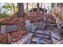 Stone steps leading to a charming home nestled in the woods at 1379 The By Ne Way, Atlanta, GA 30306