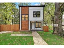 Modern two-story house with wood and white exterior, landscaped lawn, and fenced yard at 1930 Pinedale Nw Dr, Atlanta, GA 30314
