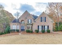 Brick two-story house with landscaping and a large front yard at 4120 Sugar Creek Ln, Cumming, GA 30041