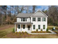 Two-story house with gray siding, white brick accents, and a covered porch at 494 Hancock Se Dr, Atlanta, GA 30354