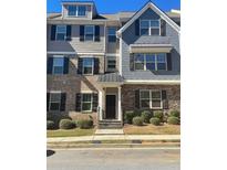 Three-story townhome with brick and siding exterior, multiple windows, and a front entryway at 3810 Equity Ln, Powder Springs, GA 30127