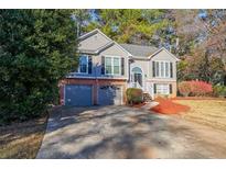 Charming two-story home with a two-car garage and landscaped front yard at 242 Viola Dr, Dallas, GA 30157