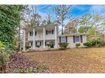 Brick house with covered entry and manicured landscaping at 3390 Glenview Sw Cir, Atlanta, GA 30331