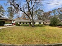 Charming ranch home with a spacious front yard and mature trees at 522 Jo Ann Se Dr, Marietta, GA 30067