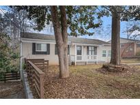 Updated ranch home with a landscaped yard and driveway at 6979 Bruce Cir, Lithonia, GA 30058