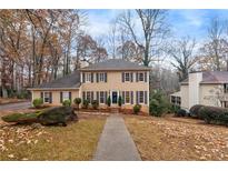 Two-story house with tan siding, gray shutters, and a walkway at 460 Springs End Ne Ln, Marietta, GA 30068