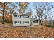 Newly renovated ranch home with a large front yard and green shutters at 4051 Glenda Dr, College Park, GA 30337