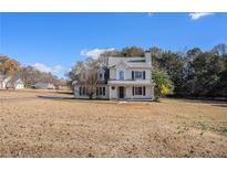 Two-story house with a large yard and attached garage at 100 Bailey Ct, Fayetteville, GA 30215