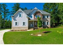 Charming two-story home with mixed siding, stone accents, and lush landscaping at 119 Terrace View Dr, Acworth, GA 30101
