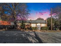 Brick building with glass block windows, metal roof, and gated entrance at 1112 Delaware Se Ave, Atlanta, GA 30316