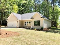 Charming new construction home with a spacious front yard at 4230 Moore Rd, Conley, GA 30288