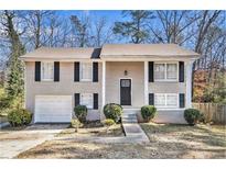Charming two-story home with brick exterior, front entry, and attached garage at 1767 Big Horn Se Ct, Conyers, GA 30013