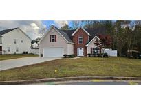 Brick and siding two-story house with attached garage and manicured lawn at 3520 Bethesda Park Ct, Lawrenceville, GA 30044