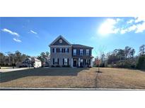 Two-story home with a gray and stone exterior and a landscaped front yard at 5257 Shorthorn Way, Powder Springs, GA 30127