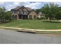 Large front yard with a two-story brick and shingle home at 1880 Hays Farm Walk, Marietta, GA 30064