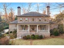 Brick Georgian style home with front porch and landscaped lawn at 195 Worth Dr, Atlanta, GA 30327