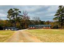 Ranch-style home with attached garage and large yard at 1824 Smith Store Rd, Covington, GA 30016