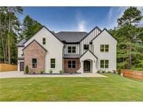 Two-story home with brick and white exterior, a large front yard, and a three-car garage at 2626 Sardis Way, Buford, GA 30519