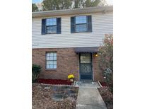 Inviting two-story home with brick and siding exterior, landscaping, and walkway at 2705 Greystone Pl, Austell, GA 30106