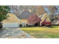 Charming two-story home with a three-car garage, landscaped yard, and mature trees at 800 Old Paper Mill Se Dr, Marietta, GA 30067