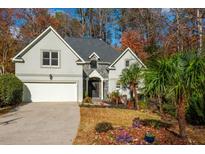 Two-story house with stone accents, landscaping, and a two-car garage at 1472 Lachona Ct, Atlanta, GA 30329