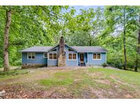 Ranch style home with blue siding, stone accents and a spacious yard at 4985 Watkins Ct, Winston, GA 30187