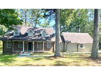 Brick ranch home with attached garage and large yard at 5940 Old Bill Cook Rd, Atlanta, GA 30349
