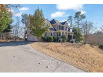 Two-story house with brick accents and a large front porch at 102 Twilight Overlook, Canton, GA 30114