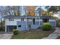 Newly painted ranch home with a carport and landscaped yard at 2652 Winthrop Rd, Atlanta, GA 30337