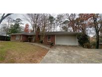 Brick ranch house with attached garage and large yard at 6698 Brandon Mill Rd, Atlanta, GA 30328