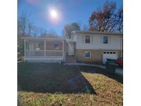 Ranch style home with covered porch and attached garage at 453 Allgood Cir, Stone Mountain, GA 30083