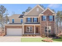 Inviting two-story home with brick and siding exterior, front porch, and attached garage at 6101 Marigold Way, Atlanta, GA 30349