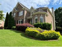 Brick two-story house with landscaped lawn at 1515 Juneau Way, Grayson, GA 30017