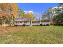 Charming single-story home with a covered front porch and large front yard at 125 Steeplechase Dr, Mcdonough, GA 30252