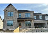 Two-story brick home with a gray roof and large windows at 4045 Hosch Retreat Drive, Buford, GA 30519