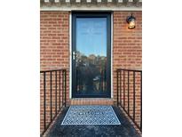 Inviting front door with a welcome mat and black railing at 1166 Booth Sw Rd # 610, Marietta, GA 30008