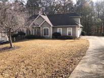 Front exterior view of a two-story home with a driveway and front lawn at 209 Cobblestone Cv, Sharpsburg, GA 30277