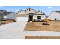 Charming two-story home with a two-car garage and landscaped yard at 3934 Saddle Bag Ct, Dacula, GA 30019