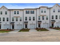 Row of new white townhouses with black trim and attached garages at 148 Werner Brook Sw Way, Atlanta, GA 30354