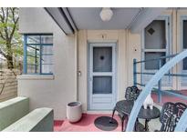 Charming front entrance with a blue door, metal table and chairs, and potted plant at 589 Auburn Ne Ave # H, Atlanta, GA 30312