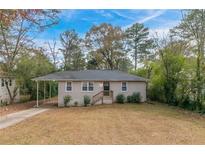 Ranch style home with carport and landscaped lawn at 2479 Brentwood Rd, Decatur, GA 30032